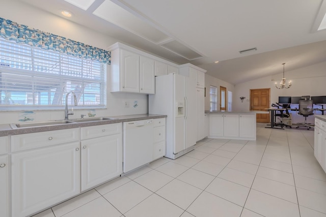 kitchen with lofted ceiling, white appliances, sink, a notable chandelier, and white cabinetry