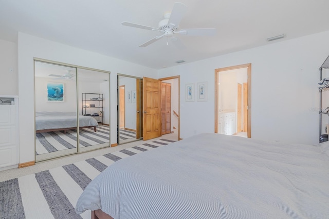 carpeted bedroom with multiple closets and ceiling fan