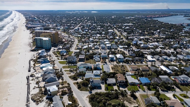 drone / aerial view featuring a water view and a view of the beach