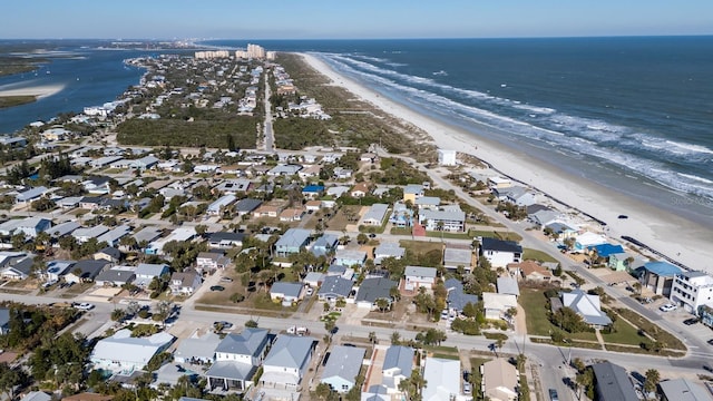 birds eye view of property featuring a water view and a view of the beach