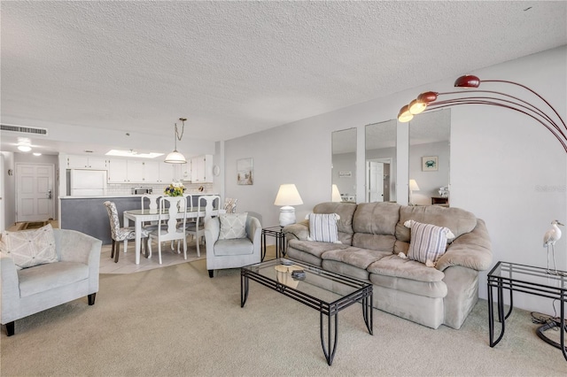 carpeted living room featuring a textured ceiling