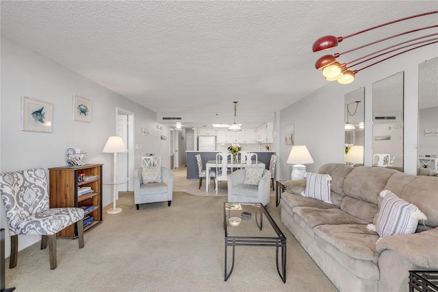 carpeted living room featuring a textured ceiling