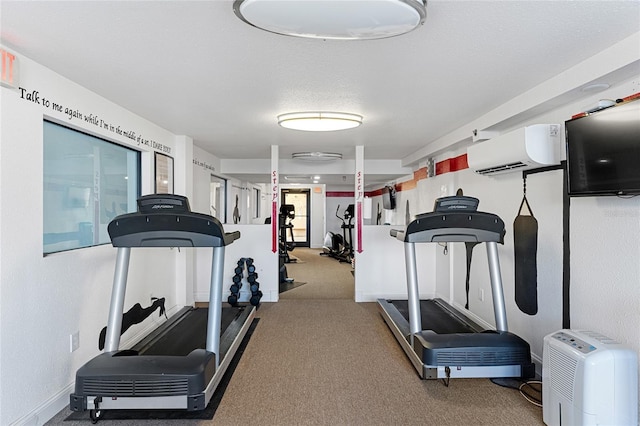 exercise area featuring carpet flooring, a textured ceiling, and a wall mounted AC