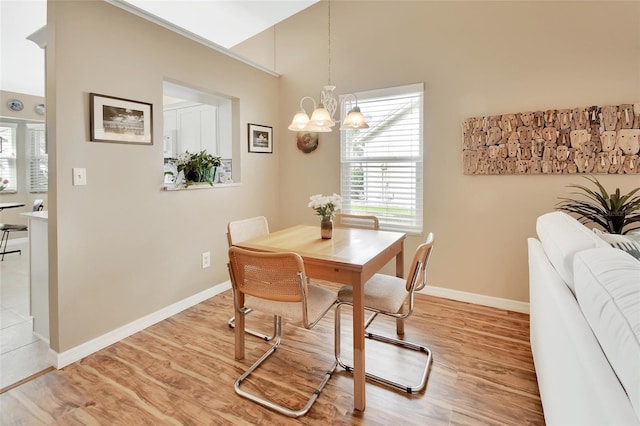 dining room featuring a chandelier and light wood-type flooring