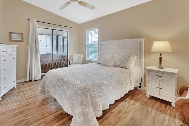 bedroom with ceiling fan, lofted ceiling, and light hardwood / wood-style flooring