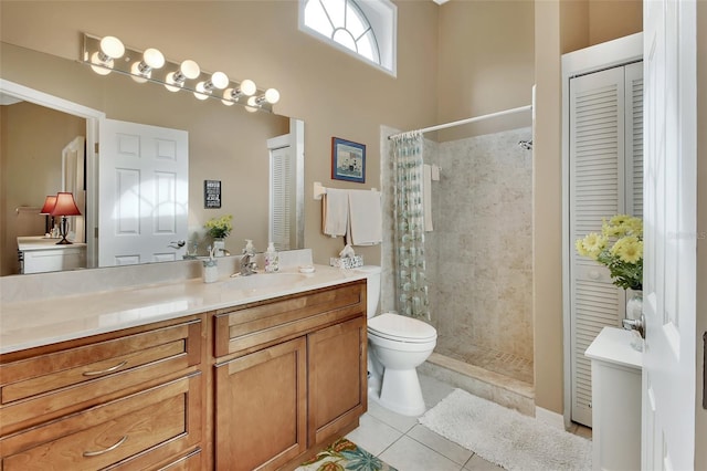 bathroom featuring a shower with curtain, tile patterned flooring, vanity, and toilet