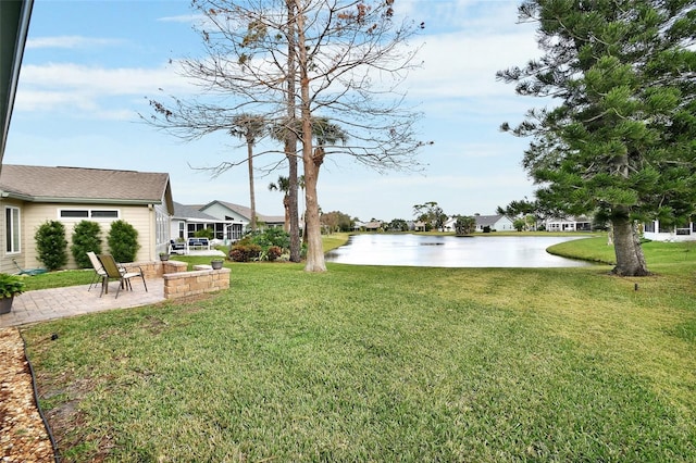 view of yard with a patio and a water view