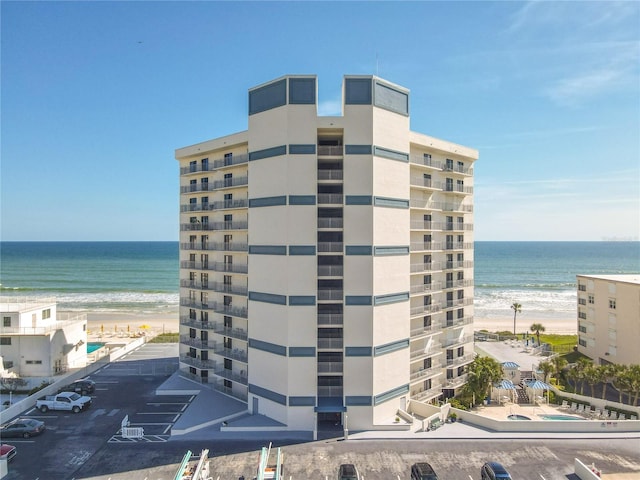 view of property featuring a view of the beach and a water view