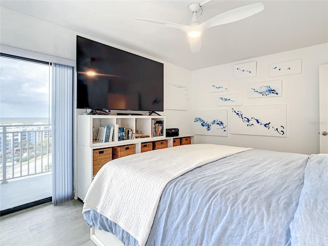 bedroom featuring access to outside, multiple windows, and ceiling fan