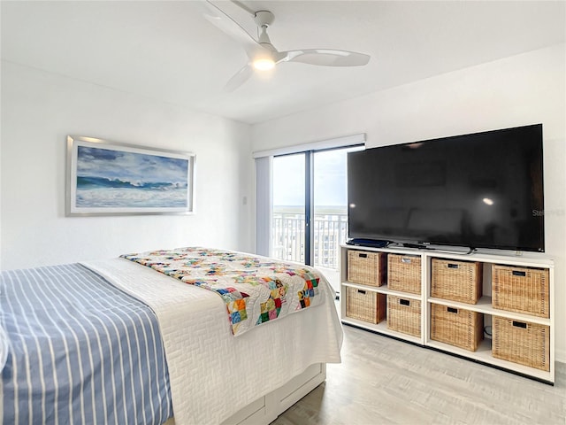 bedroom featuring access to exterior, ceiling fan, and light hardwood / wood-style floors