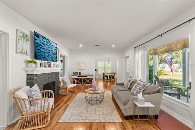 living room with a fireplace and hardwood / wood-style floors