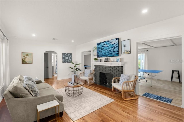 living room with wood-type flooring and a fireplace