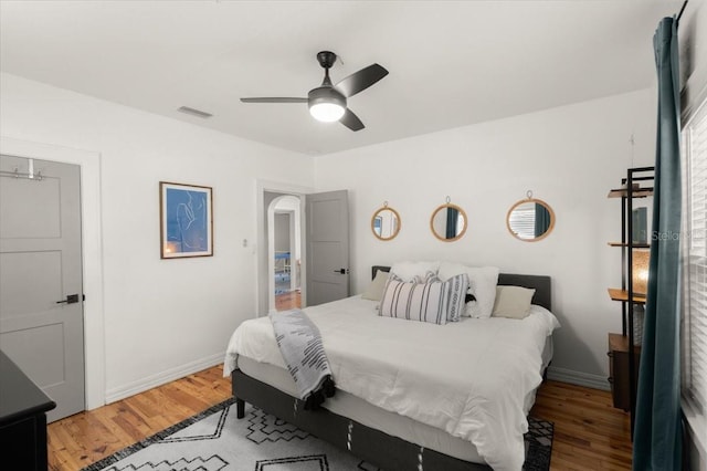 bedroom with ceiling fan and wood-type flooring