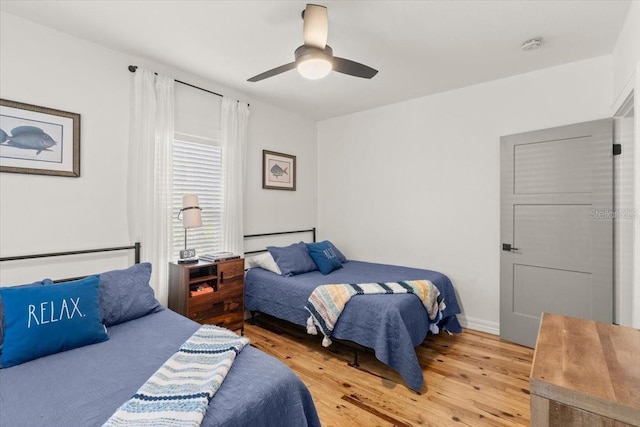 bedroom with hardwood / wood-style flooring and ceiling fan