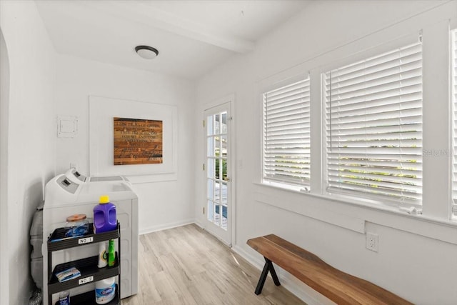 laundry area with washer and clothes dryer and light hardwood / wood-style flooring