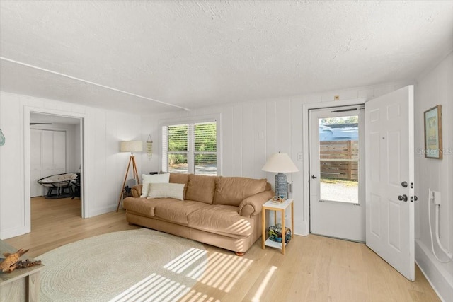 living room with plenty of natural light and light wood-type flooring