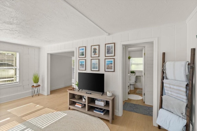 bedroom featuring ensuite bath and light hardwood / wood-style floors