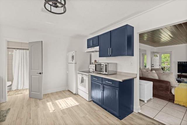 kitchen featuring white appliances, light hardwood / wood-style flooring, and blue cabinets