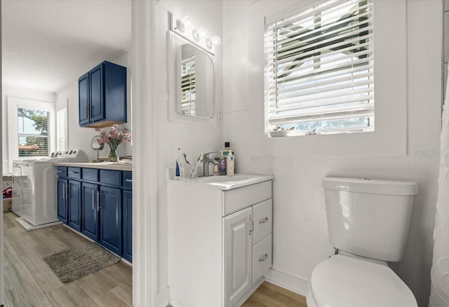 bathroom with vanity, washer / clothes dryer, wood-type flooring, and toilet