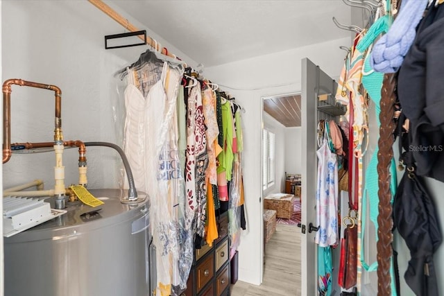 spacious closet featuring light hardwood / wood-style floors and water heater