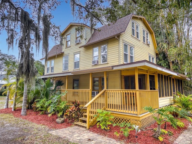 view of front facade with covered porch and cooling unit