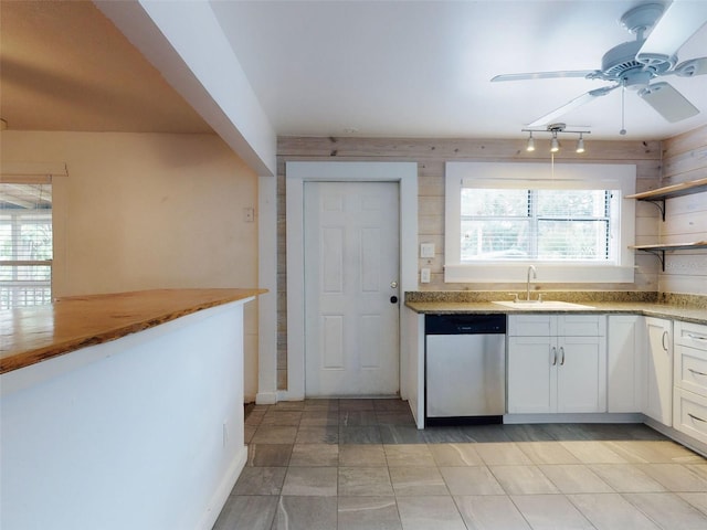 kitchen with sink, ceiling fan, white cabinetry, and stainless steel dishwasher