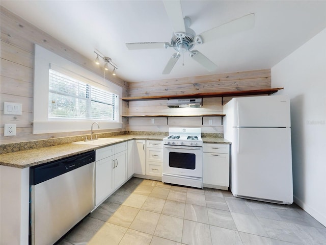 kitchen with white appliances, white cabinets, ceiling fan, and sink