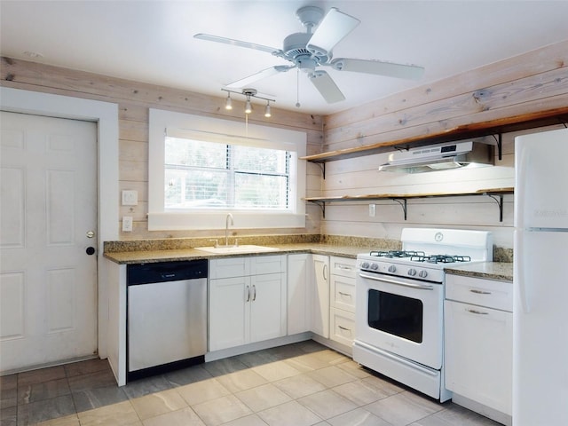 kitchen featuring white appliances, stone counters, ceiling fan, white cabinets, and sink