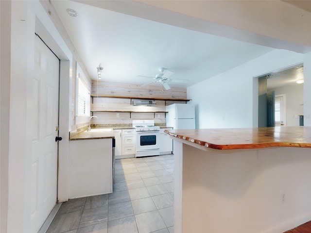 kitchen featuring sink, white appliances, butcher block countertops, and ceiling fan