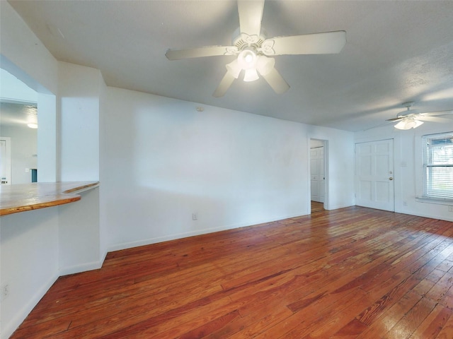 unfurnished living room with ceiling fan and hardwood / wood-style flooring