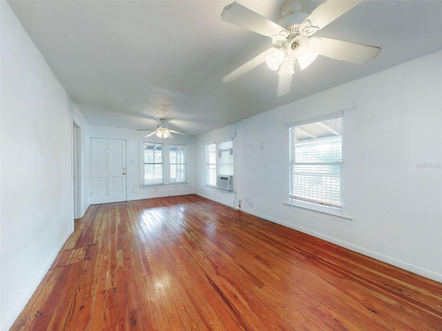 unfurnished room with ceiling fan, hardwood / wood-style floors, and cooling unit