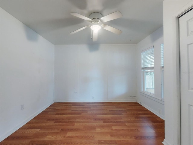 unfurnished room with ceiling fan and wood-type flooring