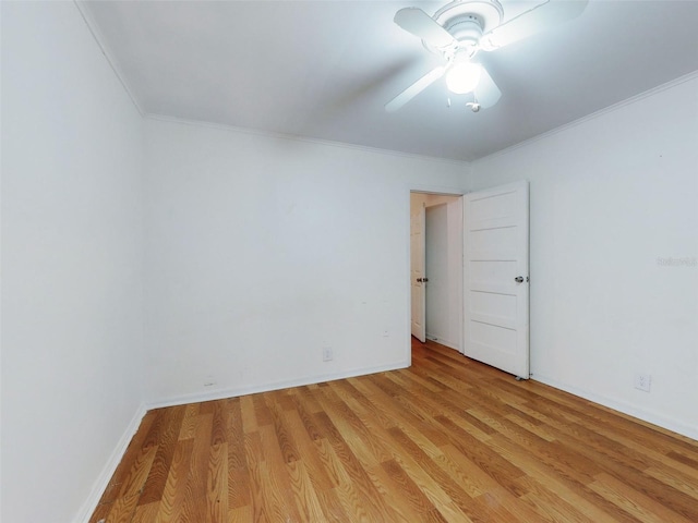 empty room with ornamental molding, ceiling fan, and light hardwood / wood-style floors