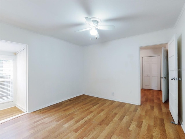 unfurnished room with light wood-type flooring and ceiling fan