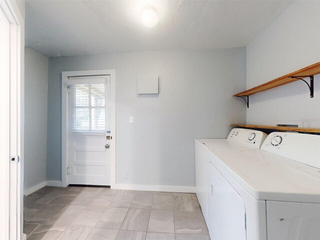 clothes washing area with washing machine and clothes dryer