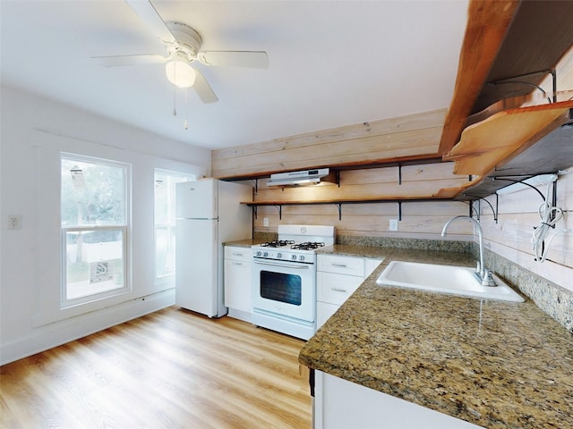 kitchen featuring white appliances, light wood-type flooring, ceiling fan, sink, and white cabinetry