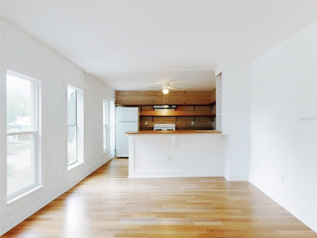 unfurnished living room with light hardwood / wood-style floors and ceiling fan