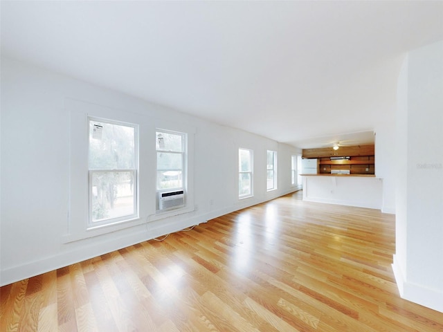 unfurnished living room featuring light wood-type flooring and cooling unit