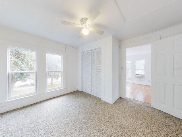 unfurnished bedroom featuring ceiling fan, a closet, and carpet floors