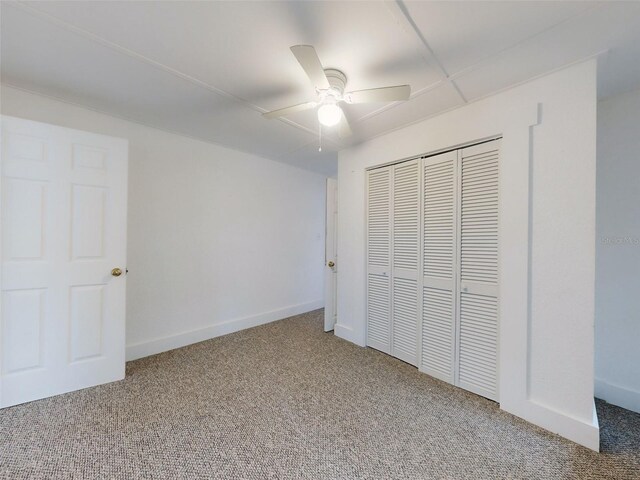 unfurnished bedroom featuring carpet flooring, a closet, and ceiling fan