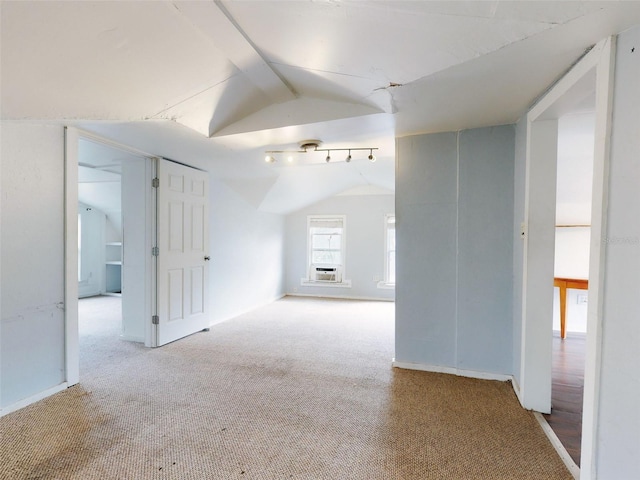 carpeted empty room with lofted ceiling and cooling unit