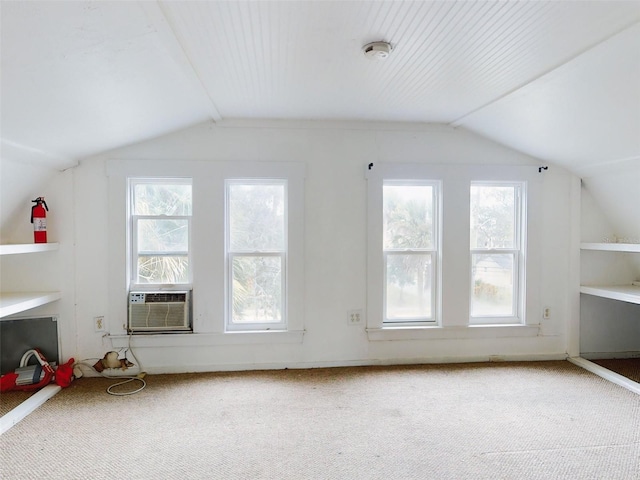 bonus room featuring a wealth of natural light, lofted ceiling, and carpet