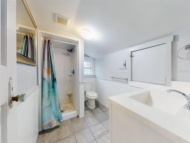 bathroom with vaulted ceiling, toilet, vanity, a shower with curtain, and tile walls