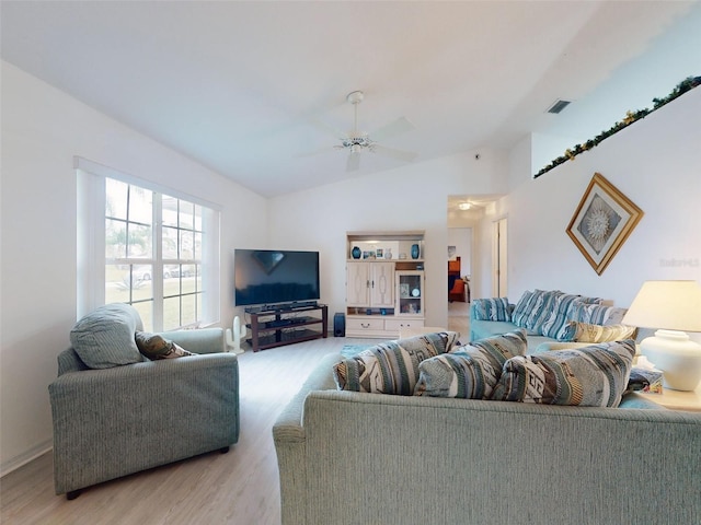 living room with ceiling fan, lofted ceiling, and light wood-type flooring