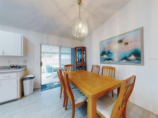 dining space featuring an inviting chandelier and light hardwood / wood-style flooring