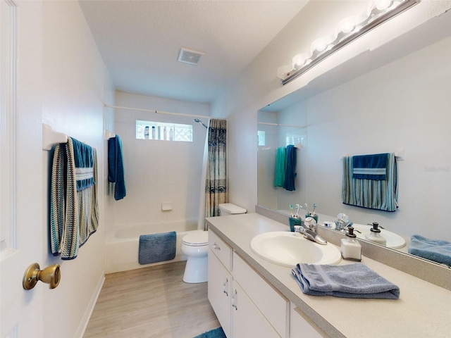 full bathroom featuring wood-type flooring, toilet, vanity, and shower / bathtub combination with curtain