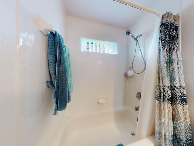 bathroom with shower / bath combination with curtain