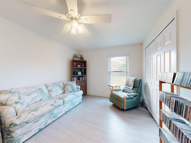 living room with ceiling fan and light hardwood / wood-style floors