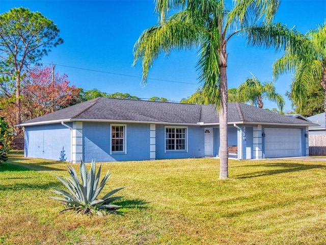 single story home featuring a garage and a front yard