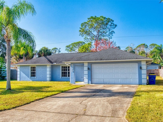 ranch-style home with a garage and a front lawn